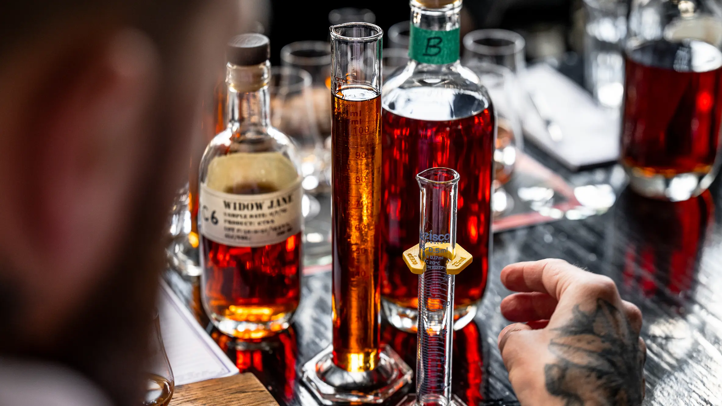 Two graduated cylinders of Borough Blend next to the bottles